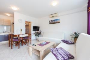 a living room with a couch and a table at Apartman Studio in Pula