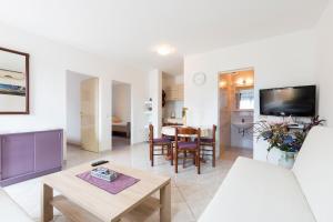 a living room with a couch and a table at Apartman Studio in Pula