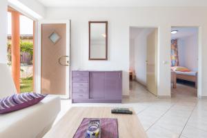a living room with a couch and a table at Apartman Studio in Pula