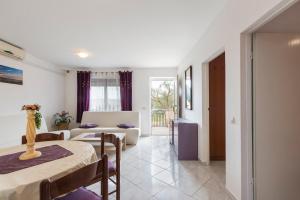 a living room with a bed and a couch at Apartman Studio in Pula