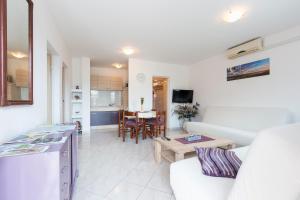 a living room with a couch and a table at Apartman Studio in Pula