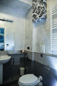 a bathroom with a white toilet and a sink at Art in B&B in Salerno