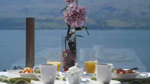 a table with a vase with a flower on it at Bella Luna Bed and Breakfast in West Kelowna