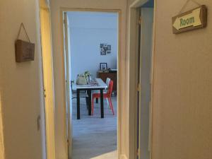 a hallway with a table and a room with a dining room at Beach Houses in Costa da Caparica