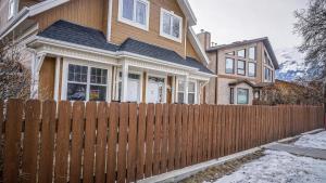 a wooden fence in front of a house at Valencia Suite - 2 Bedroom basement in Jasper