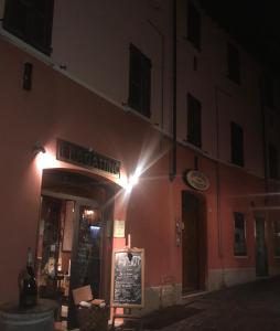 a restaurant with a sign on the side of a building at Casa Bagatta in Desenzano del Garda