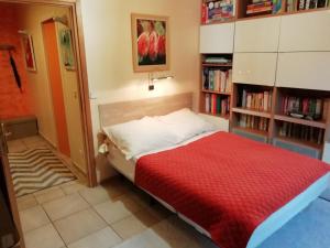 een slaapkamer met een bed met een rode deken bij Chambre plein comfort in Vimy