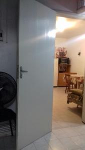 a door leading into a living room with a table at Apartamento kitchenette in São Lourenço do Sul