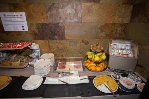 a table with a buffet of food on it at Hotel Yerri in Estella