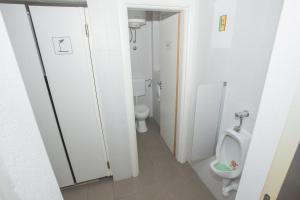 
a white toilet sitting next to a white sink at Tchaikovsky Hostel Split (T-Hostel) in Split

