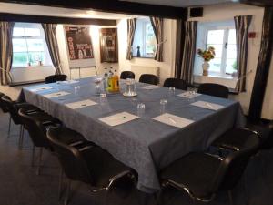 a large table with chairs and a blue table cloth at Apple Tree Hotel in Bridgwater