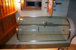 a glass shower in a bathroom with a sink at Quinta de la Barandica in Miranda do Douro