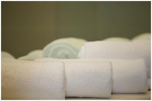 a pile of white towels sitting on top of a bed at Motel Plus Berlin in Berlin
