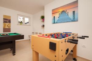 a room with a foosball table in front of a desk at Villa Nicole in Banjole