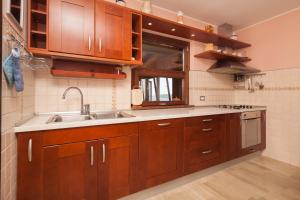 a kitchen with wooden cabinets and a sink at Villa Nicole in Banjole