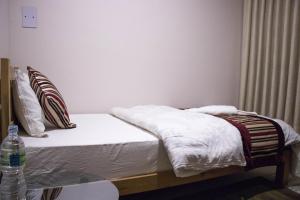 Postel nebo postele na pokoji v ubytování k2Homes