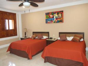 Giường trong phòng chung tại Izamal Plaza