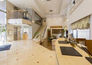 a large room with a staircase and a lobby at Imabari Urban Hotel (New Building) in Imabari