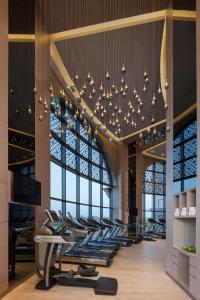 a lobby with a row of chairs under a chandelier at Hyatt Regency Dubai Creek Heights in Dubai