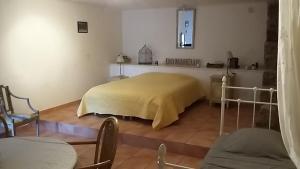 a hospital room with a bed with a yellow blanket at Chambres d'Hôtes Le Crouzat in Empurany