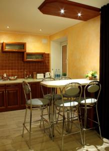 a kitchen with a round table and chairs at Apartment on Prospekt Mira in Chernihiv