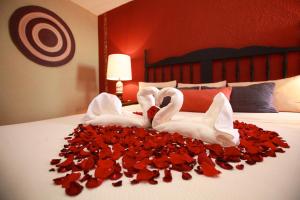two swans made out of hearts on a bed at Hotel Montetaxco in Taxco de Alarcón