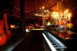 a restaurant with a bar with candles and a piano at Hotel Montetaxco in Taxco de Alarcón