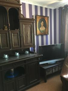 a living room filled with furniture and a tv at Hotel Kardinal in Vinnytsya
