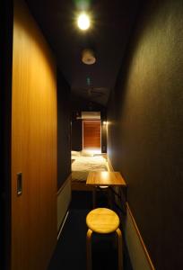 Postel nebo postele na pokoji v ubytování Yumoto Station Hotel MIRAHAKONE