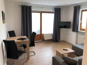 a living room with a table and a couch at Ferienwohnung Hofer in Schwangau