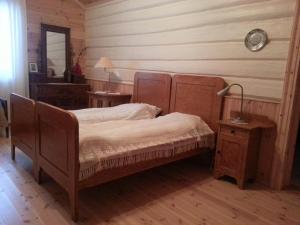 a bedroom with a bed and a table and a mirror at Bakken Gårdshus in Rendalen