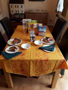 a table with plates of food on top of it at Sawbridgeworth Bed & Breakfast in Sawbridgeworth
