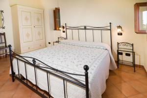 a bedroom with a bed with a white comforter at Il Glicine in Cetara