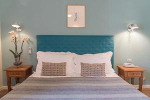 En eller flere senge i et værelse på Hotel Antica Stallera