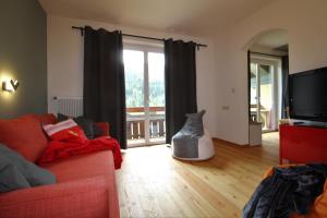 a living room with a couch and a television at RoZa´s Nest by Isa Badkleinkirchheim in Bad Kleinkirchheim