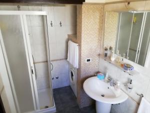 a bathroom with a sink and a shower at Dimora Cinzia in Uggiano la Chiesa +41 photos