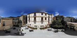 a large building in the middle of a city at B&B Palazzo Mantegna in Gioiosa Ionica