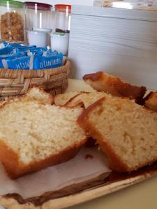 a slice of bread on a plate with a basket of bread at Le Mulinare - Bed & Breakfast in Drapia