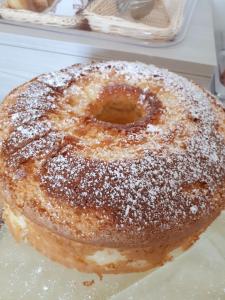 a doughnut covered in powdered sugar sitting on a table at Le Mulinare - Bed & Breakfast in Drapia