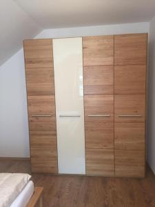 a bedroom with a large closet with wooden drawers at Ferienwohnung Steirerbusserl in Kirchdorf