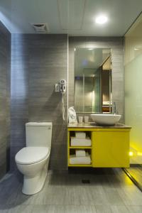 a bathroom with a white toilet and a sink at Xinshe Hotel - Hsinchu in Hsinchu City