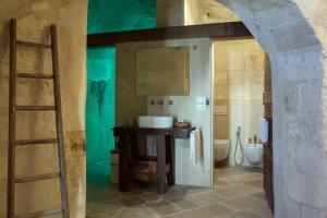 a bathroom with a ladder and a sink and a toilet at Locanda Di San Martino Hotel & Thermae Romanae in Matera +37 photos
