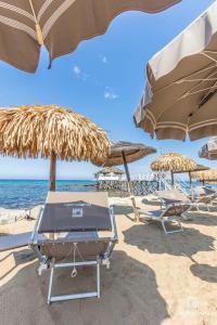 a group of chairs and umbrellas on a beach at Casavacanze Peperosa in Civitavecchia