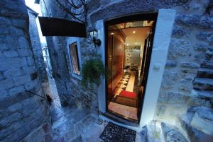 a hallway leading to a building with a doorway at Cattaro Royale Apartment in Kotor