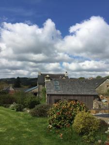 a house with a window on top of a yard at Le Gîte "Le Grand Chêne" in Le Cloître-Saint-Thégonnec