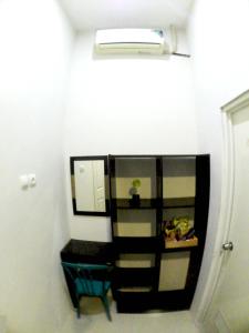 a bathroom with a mirror and a sink in a room at login homestay in Madiun
