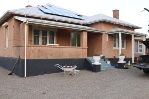a house with solar panels on top of it at Pink Gums Farmstay in Currency Creek