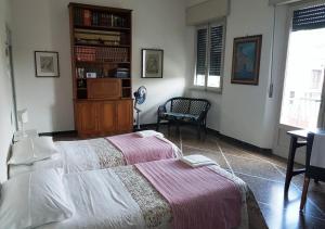 A bed or beds in a room at La Coccinella Guest House
