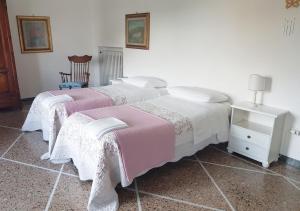 A bed or beds in a room at La Coccinella Guest House Még 15 kép
