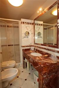 a bathroom with a sink and a toilet at Hotel La Colonnina in Monterosso al Mare